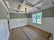 Dining room with coffered ceilings, white wainscoting, and a window providing natural light at 27 Batten Hill Ln, Selma, NC 27576