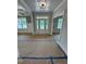 Bright entryway featuring a white door with glass panels, white trim, and contemporary lighting fixture at 27 Batten Hill Ln, Selma, NC 27576