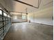 Large garage with concrete floors and a garage door at 27 Batten Hill Ln, Selma, NC 27576