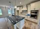 Spacious kitchen with a large island, stainless steel appliances, and white cabinetry at 27 Batten Hill Ln, Selma, NC 27576