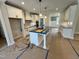 Kitchen with a large island, white cabinetry, and modern lighting fixtures, perfect for cooking at 27 Batten Hill Ln, Selma, NC 27576