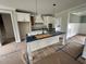 Well-appointed kitchen with a large island, modern lighting, and access to dining and living areas at 27 Batten Hill Ln, Selma, NC 27576