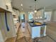 Kitchen featuring an island with seating, white cabinets, and modern appliances at 27 Batten Hill Ln, Selma, NC 27576