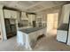 Well-lit kitchen featuring custom cabinetry and a central island, awaiting personalized finishing touches and appliances at 27 Batten Hill Ln, Selma, NC 27576