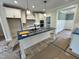 Bright kitchen with a large island, white cabinetry, and modern appliances, perfect for cooking and entertaining at 27 Batten Hill Ln, Selma, NC 27576