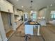 Well-lit kitchen featuring a large island, white cabinets, and contemporary fixtures at 27 Batten Hill Ln, Selma, NC 27576
