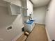 Laundry room with white cabinets, sink, and connections for a washer and dryer at 27 Batten Hill Ln, Selma, NC 27576
