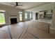 Open-concept living room featuring a fireplace, access to the kitchen, and plenty of natural light at 27 Batten Hill Ln, Selma, NC 27576