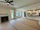 Open-concept living room flowing into a modern kitchen, with a fireplace and plenty of natural light at 27 Batten Hill Ln, Selma, NC 27576