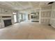 Open-concept living room and kitchen with fireplace at 27 Batten Hill Ln, Selma, NC 27576