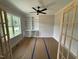 Bright office with built-in bookshelves, ceiling fan, and large windows for natural light at 27 Batten Hill Ln, Selma, NC 27576