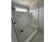 Stylish walk-in shower featuring a modern design with marble-style tile and a built-in bench at 27 Batten Hill Ln, Selma, NC 27576