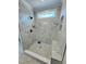 Modern walk-in shower with marble-like tile, a built-in bench, and a rainfall shower head at 27 Batten Hill Ln, Selma, NC 27576