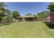 Spacious backyard with well-maintained lawn and covered patio, ideal for outdoor activities and relaxation at 2715 Freemont Rd, Durham, NC 27705