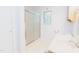 Bright bathroom featuring glass shower, light-colored walls, and a window that provides natural light at 2715 Freemont Rd, Durham, NC 27705