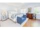 Bright bedroom featuring a wrought iron bed, soft lighting, and hardwood floors with area rug at 2715 Freemont Rd, Durham, NC 27705