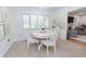 Bright breakfast nook with a white table and chairs, bathed in natural light from a large window at 2715 Freemont Rd, Durham, NC 27705