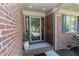 Inviting front entryway with a glass door, brick accents, and charming decorative details for a warm welcome at 2715 Freemont Rd, Durham, NC 27705