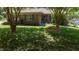 Attractive brick house with mature trees and a decorative bench on a spacious, well-maintained lawn at 2715 Freemont Rd, Durham, NC 27705