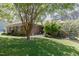 Well-maintained single-story brick home with lush green lawn and established landscaping, offering great curb appeal at 2715 Freemont Rd, Durham, NC 27705