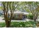 Lovely brick home with a beautifully landscaped yard and mature trees providing shade and character at 2715 Freemont Rd, Durham, NC 27705