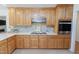 Well-lit kitchen featuring wood cabinets, stainless steel appliances and stylish backsplash at 2715 Freemont Rd, Durham, NC 27705