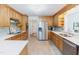 Bright kitchen featuring wooden cabinets, stainless steel appliances, and tile flooring at 2715 Freemont Rd, Durham, NC 27705