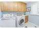 Functional laundry room with washer, dryer, cabinets, and ample counter space at 2715 Freemont Rd, Durham, NC 27705