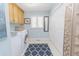 Clean laundry room with modern appliances, storage cabinets, and a decorative rug at 2715 Freemont Rd, Durham, NC 27705