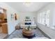 Bright living room with a sofa, round coffee table, blue patterned rug, and view to kitchen at 2715 Freemont Rd, Durham, NC 27705