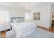 Bright main bedroom with a plush bed, modern chandelier, and soft decor at 2715 Freemont Rd, Durham, NC 27705