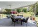 Covered outdoor patio with a dining set and additional seating, overlooking the landscaped backyard at 2715 Freemont Rd, Durham, NC 27705