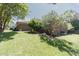 Brick home with a well-manicured side yard, including mature landscaping and lush green lawn at 2715 Freemont Rd, Durham, NC 27705