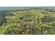Expansive land for sale, showcased by aerial view with property lines marked, surrounded by lush trees and natural water features at 2925 Ericka Dr, Hillsborough, NC 27278