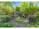 Inviting backyard featuring stone patio with a dining area and pergola at 2925 Ericka Dr, Hillsborough, NC 27278