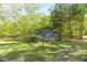 Rustic barn nestled among mature trees, perfect for storage or a workshop at 2925 Ericka Dr, Hillsborough, NC 27278
