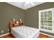 Bedroom with olive green walls, a ceiling fan, wood floors and a bright window view at 2925 Ericka Dr, Hillsborough, NC 27278