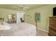 This bedroom has a four poster bed, a ceiling fan, and a dresser with mirror at 2925 Ericka Dr, Hillsborough, NC 27278