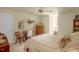 The bedroom features a traditional aesthetic with a four-poster bed, side chair, and window seat at 2925 Ericka Dr, Hillsborough, NC 27278
