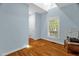This is a spacious bedroom with hardwood floors, a window, and light blue walls at 2925 Ericka Dr, Hillsborough, NC 27278