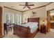 Primary bedroom with paneled windows, ceiling fan, and en suite bathroom at 2925 Ericka Dr, Hillsborough, NC 27278