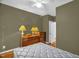 Bedroom with olive green walls, wood floors and a bureau with lamps at 2925 Ericka Dr, Hillsborough, NC 27278