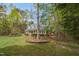 A beautiful one-story home with a full porch and mature trees bordering the perimeter of the large front yard at 2925 Ericka Dr, Hillsborough, NC 27278