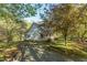 Charming two-story home surrounded by lush greenery and a gravel driveway at 2925 Ericka Dr, Hillsborough, NC 27278