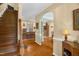Open-concept home featuring wooden stairs, hardwood floors, neutral-toned walls, and multiple entryways to different spaces at 2925 Ericka Dr, Hillsborough, NC 27278