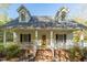 Charming two-story home featuring dormer windows, a brick foundation, and a welcoming front porch at 2925 Ericka Dr, Hillsborough, NC 27278