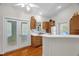 Vaulted kitchen with wood cabinets, stainless steel sink and adjacent sliding glass doors at 2925 Ericka Dr, Hillsborough, NC 27278