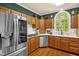 Traditional kitchen features stainless steel appliances, wood cabinets, and natural light from a large window at 2925 Ericka Dr, Hillsborough, NC 27278