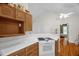 Vaulted kitchen with wood cabinets, white counter tops, and white appliances at 2925 Ericka Dr, Hillsborough, NC 27278