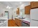 Vaulted kitchen with wood cabinets, white counter tops, stainless steel sink, and dishwasher at 2925 Ericka Dr, Hillsborough, NC 27278